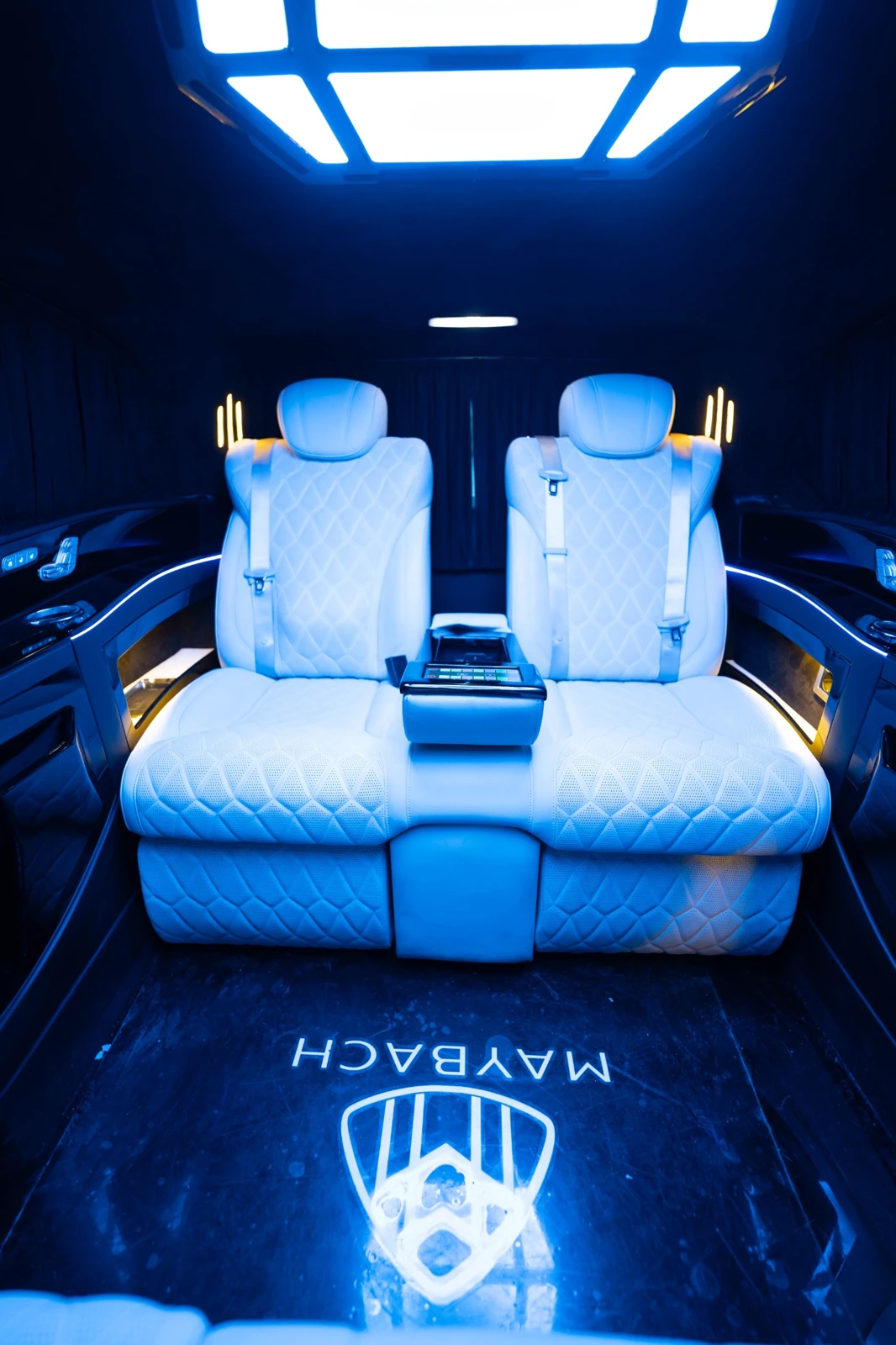 Real van cabin with light-coloured seats and illuminated ceiling