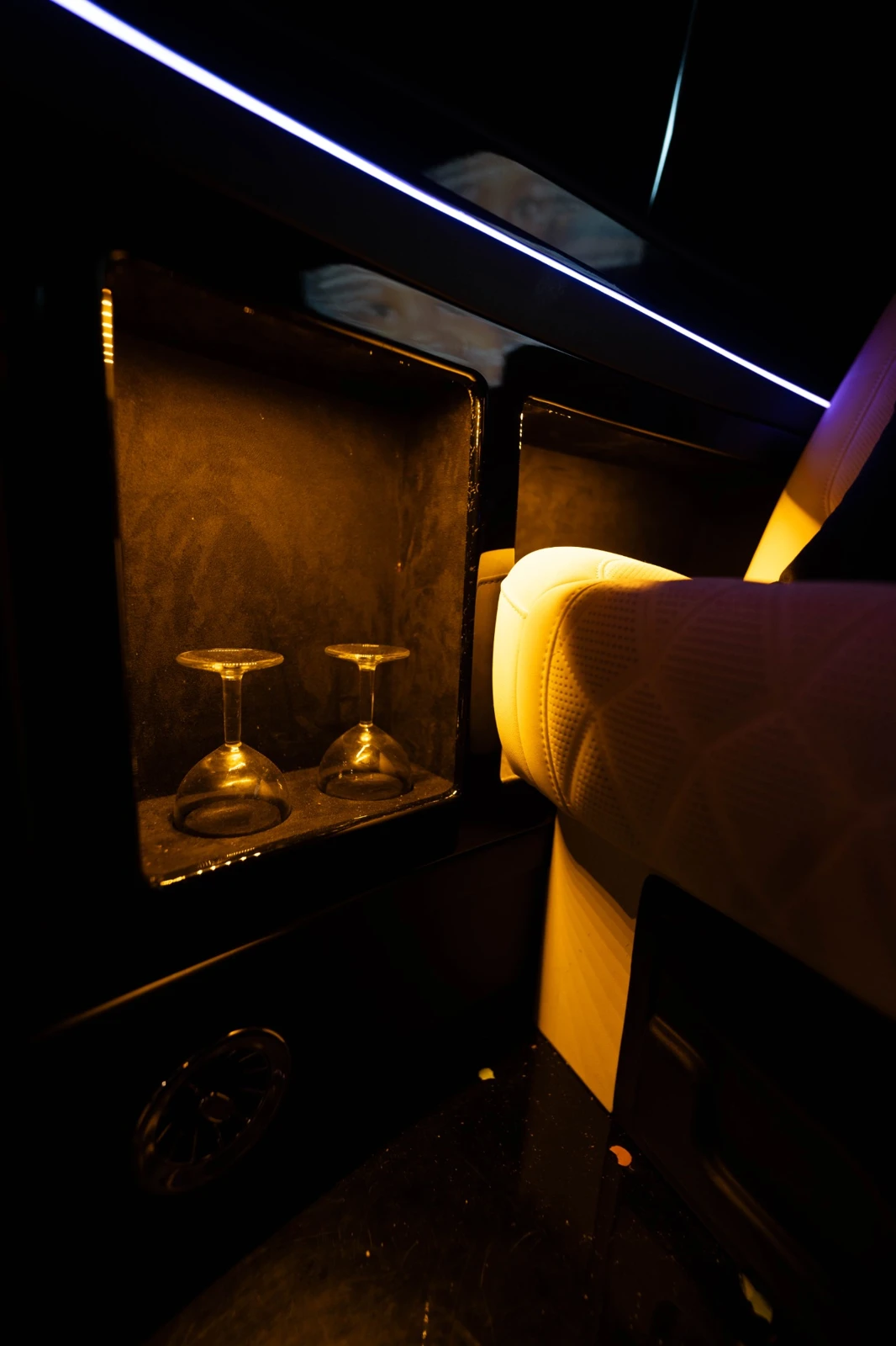 Glassware compartment beside a seat in the AFM LUXURY van